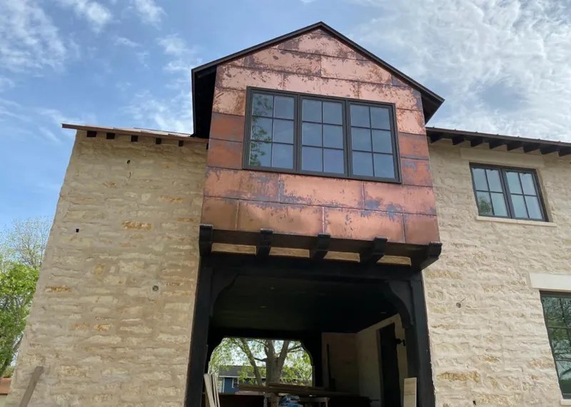Copper metal panel facade on a stone building for Skylight Installation in North Weeki Wachee